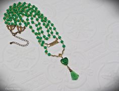 "A gorgeous Jade glass multi strand Art Deco necklace in classic Egyptian Revival style with vintage jade glass beads and cabochons. It makes the perfect handmade women's gift for anyone who loves vintage style Egyptian jewelry. Made from strands of 6mm vintage Cherry brand jade glass beads, a brass Sphinx connector charm, and a 14mm Jade glass heart-shaped scarab with a textured, mixed light and dark Jade glass fan pendant. The smallest row in this necklace measures 15\" closest to the throat, Vintage Multi-strand Gemstone Beads Necklace, Vintage Multi-strand Gemstone Bead Necklaces, Vintage Multi-strand Gemstone Beads Jewelry, Adjustable Vintage Jade Necklace, Vintage Adjustable Jade Necklace, Adjustable Vintage Jade Necklaces, Vintage Adjustable Jade Necklaces, Vintage Jade Beaded Necklace, Vintage Jade Beaded Necklaces