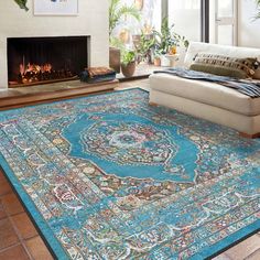 a living room with a large rug on the floor and a fire place in the corner