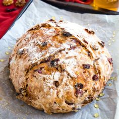 a loaf of bread sitting on top of a piece of tin foil covered in powdered sugar