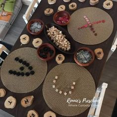 a wooden table topped with lots of different types of letters and numbers on top of it