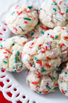 a white plate topped with cookies covered in sprinkles