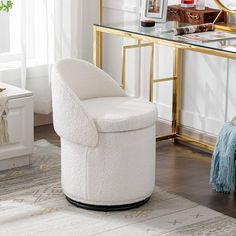 a white chair sitting on top of a wooden floor next to a desk and mirror