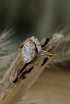 a close up of a ring on top of a piece of wood