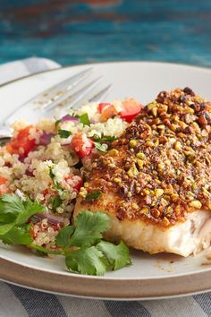 a white plate topped with fish and rice