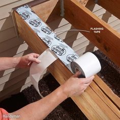 a person holding a roll of toilet paper near a wooden bench with steps on it