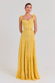 Miranda Yellow Dress Women's Clothing > Dresses.    DESCRIPTION & FEATURES   MIRANDA is a lace maxi dress, crafted from yellow lace with a nude mesh lining, featuring elegant bow-detailed straps, a sweetheart cupped neckline to the front and square to the back, an underwire bust with padding, and a structured bodice with external corset detailing. The elegant maxi features a three-tiered skirt that gathers and a detachable self-fabric buckle belt.     - Yellow lace fabric  - Sweetheart neckline Yellow Lace Dress Outfit, Womens Yellow Dress, Three Tiered Skirt, Nadine Merabi, Yellow Lace, Lace Maxi, Wedding Guests, Lace Maxi Dress, Yellow Dress