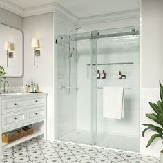 a bathroom with a sink, toilet and shower stall in the middle of it is shown