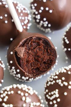 chocolate covered desserts with white sprinkles on a plate