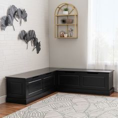 a room with a large rug and shelves on the wall, along with a black bench