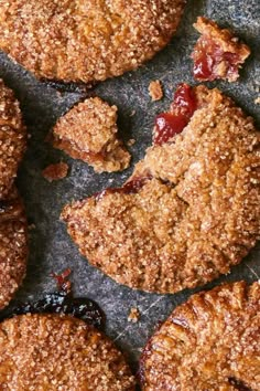 several cookies with crumbled toppings are arranged on a table