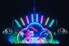 an illuminated stage with colorful lights in the dark