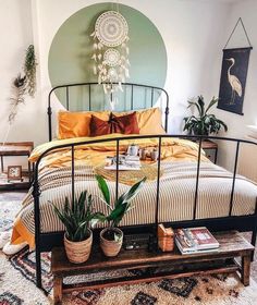 a bed room with a neatly made bed and potted plants