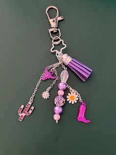 a purple key chain with charms attached to it