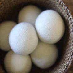 four white balls are in a brown basket