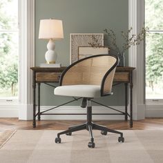 an office chair sitting on top of a wooden desk next to a lamp and window