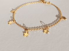 "This star bracelet in gold vermeil(more durable than gold plated) or rhodium silver has 5 handmade little, smooth, and tiny dangling stars. This celestial bracelet is the dainty, boho, and delicate charm bracelet that you need in your jewelry collection! Imagine wearing this silver charm bracelet every day and with all your outfits... You will be amazing! Or, imagine it as your bridesmaid gift to ask them \"would you be my bridesmaid\"... They will love it! I can write them a special note from Gold Bracelet With Star Charm, Adjustable Celestial Bracelets With Star Charm, Gold Bracelet Jewelry With Star Charm, 14k Gold-filled Star Charm Jewelry, Adjustable Gold Chain Bracelet With Star Charm, Celestial Charm Bracelet With Star Charm As Gift, Celestial Star Charm Bracelet Gift, Adjustable Gold Celestial Charm Bracelet, Dainty Adjustable Chain Bracelet With Star Charm