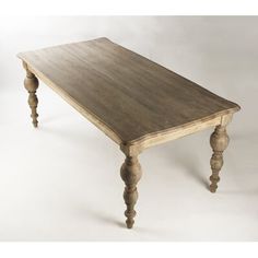 a wooden table with turned legs on a white background