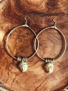 "Handmade brass hoops featuring African masks and textured brass beads that were made by African artisans. *The mask on each pair of hoops will vary is style and size. No 2 are alike. DETAILS: Metal: Brass Size:3\" Gold plated ear wire Ships with polishing cloth *The mask and beads have been left un-polished and May feature some patina. Return to shop: Afrohemien.etsy.com Like and Follow Afrohemien for updates, sales, coupons and surprise giveaways Instagram/Blog: instagram.com/Afrohemien Tumblr Festive Brass Hoop Earrings With Ear Wire, Festive Handmade Brass Hoop Earrings, Traditional Adjustable Brass Hoop Earrings, Traditional Brass Hoop Earrings With Ear Wire, Oxidized Brass Hoop Earrings, Brass Hoop Earrings With Oxidized Finish, Bohemian Bronze Hoop Earrings In Brass, Bohemian Bronze Brass Hoop Earrings, Festival Bronze Brass Hoop Earrings