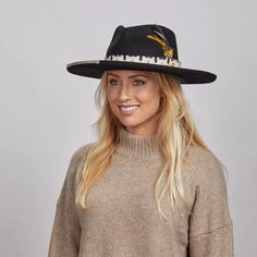 Lounge | Womens Black Pencil Rim Felt Hat exudes a sophisticated yet bold look. Made from firm Australian felt wool with a 4" curled brim, it features a unique fabric trim with twine overlay, faux wood bead, and double feathers, making it perfect for women who want to stand out in style. Material: Midweight Australian Firm Felt Wool Shape: Teardrop Curled Trim: Printed Fabric Band with Twine Overlay, Wood Bead, and Double Feather Brim Size: 4" Crown Height: 4 1/4" Sweatband: AHM Velcro Imported Straw Cowgirl Hat, Black Felt Hat, Stylish Womens Hats, White Cowboy Hat, Brown Cowboy Hat, Hats For Big Heads, American Hat Makers, Leather Cowboy Hats, American Hat