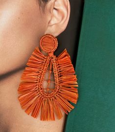 Add a touch of bohemian flair to your ensemble with our stunning Boho Orange Earrings. Handcrafted with love, these statement earrings showcase vibrant orange hues that are sure to catch everyone's attention. Made from natural fibers, these dangle earrings are sustainable and eco-friendly. Perfect for trendy events, these earrings effortlessly elevate your style with their unique design. Whether you're attending a music festival, a summer party, or a casual outing, these boho earrings are the pe Vibrant Beach Earrings, Bohemian Coral Dangle Earrings, Handmade Brown Tassel Earrings, Bohemian Orange Tassel Earrings For Party, Bohemian Tassel Earrings For Beach, Handmade Bohemian Coral Earrings, Handmade Coral Bohemian Earrings, Bohemian Teardrop Chandelier Earrings For Summer, Summer Orange Drop Earrings