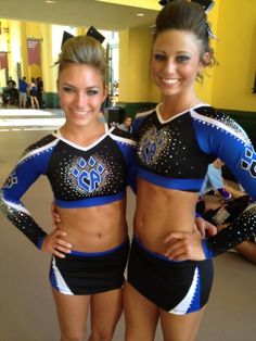 two cheerleaders are posing for the camera