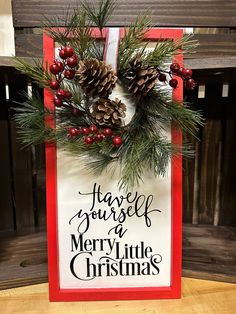 a sign that says have yourself merry little christmas with pine cones and berries on it