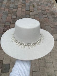 -Made in Guanajuato, Mexico -One size fits most -Stretch band to fit sizes S-L -Manmade -Shipped from Florida -15 in. L -14 in. W -6 in. H -Material felt -4 in. H Crown -hand decorated hat with shiny hat band with beautiful pearls  -This hat is perfect to add that extra touch to any outfit, and the perfect gift for brides ! Pearl Hat Band, White Hats For Women, Decorated Fedora Hats, Hat With Pearls, Decorated Hats, Pearl Hat, Casual Hats, Luxury Hats, Bride Hat