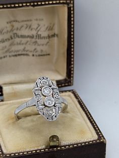 Offered,  for sale this Antique 14ct (Tested) White gold, Edwardian/ Art Deco era Diamond panel ring from my Antique  collection. The focal point of this ring are the magnificent central duet of diamonds. Each diamond is beautifully matched for cut, colour and clarity. These are a old brilliant cut diamonds  and are of very high quality, estimated as SI 1 /2 Clarity, Colour G - H. They have a beautiful fire and sparkle, very clean and extremely bright. Each diamond is in a bezel mounted in raise Art Deco Three Stone Diamond Ring, Art Deco Brilliant Cut Diamond Ring Collectible, Art Deco Collectible Diamond Ring With Brilliant Cut, Art Deco Diamond Ring For Anniversary, Art Deco Diamond Ring Stamped 14k, Art Deco 14k Stamped Diamond Ring, Art Deco Diamond White Cluster Ring For Anniversary, Art Deco 14k Diamond Ring, Art Deco Anniversary Diamond Ring With Single Cut Diamonds