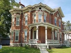 a large red brick house with white trim