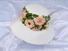 a white hat with pink flowers on it