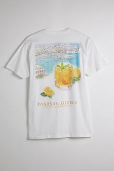 Cotton jersey t-shirt with graphic prints at the front and back. Standard fit tee with short sleeves and a ribbed crew neck. Features Mykonos Oranges graphic tee Graphic print t-shirt Crew neck Short sleeve Regular fit Content + Care 100% Cotton Machine wash Imported Size + Fit Measurements taken from size Medium Chest: 42" Length: 30" | Mykonos Oranges Graphic Tee in White, Men's at Urban Outfitters Summer Wishlist, Grafic Tees, Men's Graphic Tees, Graphic Tee Style, Stay Fresh, California Style, Barbados, Mens Graphic Tee, Mykonos