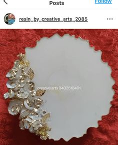 a white plate sitting on top of a red cloth covered table next to a pair of scissors