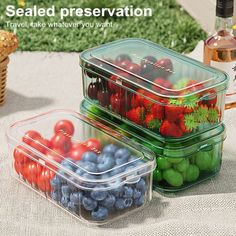 three plastic containers filled with fruit sitting on top of a cloth covered table next to a basket