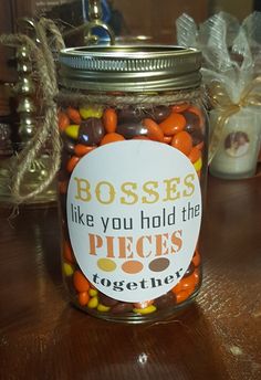 a jar filled with candy sitting on top of a wooden table