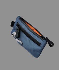 a small blue pouch with a pair of pliers in it and an orange pocket