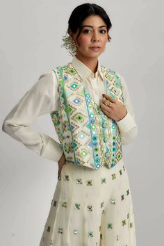 Introducing the exquisite amara jacket set with flared pants, a stunning ensemble that combines traditional craftsmanship with contemporary design. This ensemble features intricate mirror work, pompoms and tassels, along with detailed hand and machine embroidery, making it a true work of art. Traditional Hand Embellished Sets For Navratri, Hand Embellished Traditional Sets For Navratri, Festive Hand Embellished Palazzo Set For Festivals, Traditional Embellished Set With Multicolor Embroidery, Traditional Hand Embellished Sharara For Navratri, Bohemian Palazzo Set With Mirror Work For Diwali, Traditional Hand Embellished Palazzo Set For Eid, Traditional Hand Embellished Multicolor Sets, Bohemian Embroidered Sharara For Parties