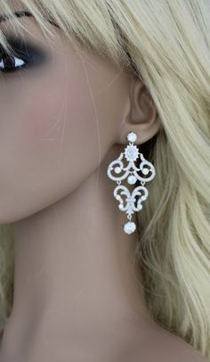 "Our rose gold bridal earrings are truly beautiful with scrolls upon scrolls of cubic zirconia encrusted elegance. At the top center of the earrings is a beautiful oval cz stone surrounded by small cz stones. These earrings are perfect for any special occasion gown. Earrings measure 2.5\" x 1.25\" MATCHING PIECES: https://www.etsy.com/listing/168621008/bridal-necklace-crystal-necklace-bridal?ref=shop_home_active_1 https://www.etsy.com/listing/525414037/rose-gold-bracelet-crystal-bridal?ref=shop_ White Cubic Zirconia Chandelier Earrings For Wedding, Intricate Dangle Bridal Earrings With Cubic Zirconia, Intricate Cubic Zirconia Dangle Bridal Earrings, Cubic Zirconia Bridal Earrings With Intricate Design, Wedding Chandelier Earrings With Intricate Cubic Zirconia Design, Intricate Design Diamond Dangle Earrings For Wedding, White Cubic Zirconia Bridal Earrings With Elegant Design, White Dangle Bridal Earrings With Intricate Design, White Bridal Earrings With Intricate Dangle Design