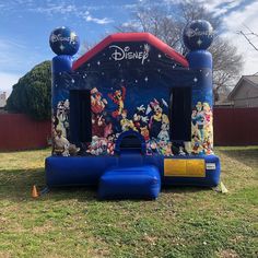 an inflatable bouncer with mickey mouse characters on it