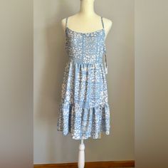 Adorable Light Blue Floral Sundress With Open Tie Back By Lala Land Creative Co. Nwt, Never Worn. Blue A-line Sundress For Beach, Light Blue Cotton Printed Dress, Light Blue Tiered Mini Dress For Beach, Blue Tiered Mini Dress For Beach, Blue Tiered Dresses For Daywear, Blue Flowy Printed Sundress, Blue Printed Sundress For Day Out, Flowy Blue Printed Sundress, Flowy Light Blue Sundress