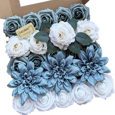 a cardboard box filled with blue and white flowers