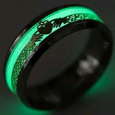 glow in the dark wedding ring with an owl and dragon on it's side