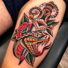 a man with a tattoo on his leg that has a snake and roses on it