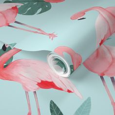 pink flamingos and green leaves on a blue wallpaper with a circular hole in the middle