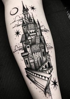 a black and white tattoo with a castle in the sky on it's arm