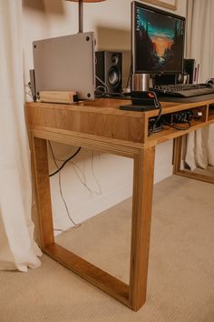 a wooden desk topped with a computer monitor and keyboard