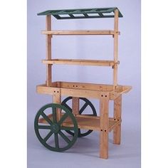 a wooden cart with green wheels and shelves on the front, against a white background