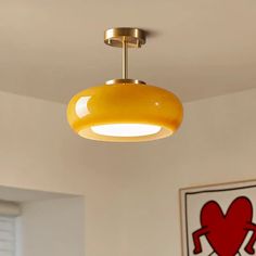 a yellow light hanging from the ceiling in a room