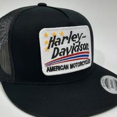 the harley davidson trucker hat is black with white and yellow stars on it's front