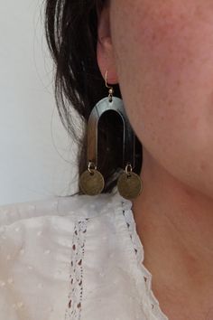 Geometric Earrings Arch Color: Black Material: Metal Circles: Color: Antique Brass Material: Brass Hardware Color: Gold Material: Iron Arches are a black metal, and the circles are antique brass. Bronze Circle Brass Earrings, Bronze Circular Brass Earrings, Retro Brass Earrings, Bronze Metal Plug Earrings, Vintage Metal Circle Earrings, Black Vintage Metal Earrings, Vintage Black Metal Earrings, Black Copper Dangle Earrings, Bronze Oxidized Metal Earrings