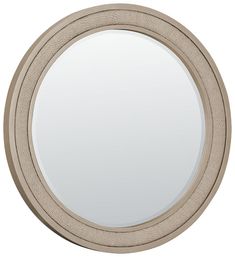 a round mirror with a beige frame